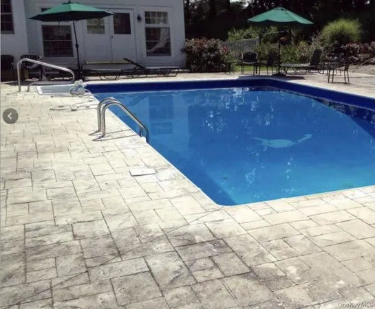 a view of swimming pool with seating space