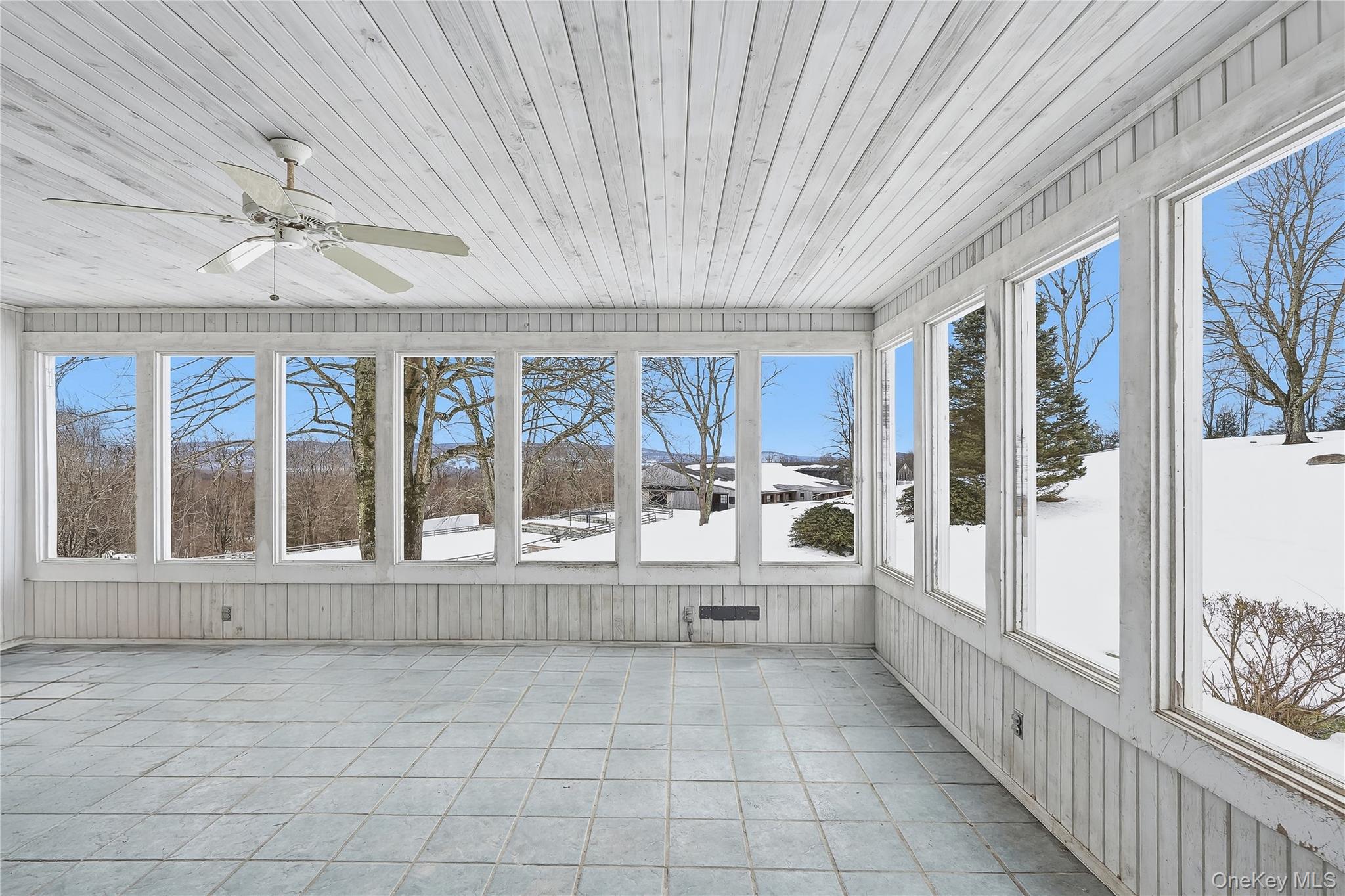 492 Mooney Hill Road, Unit 490 Patterson, NY 12563 - Photo 18 of 18 a large white room with a large window and kitchen view
