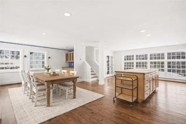 a living room with furniture a table and wooden floor