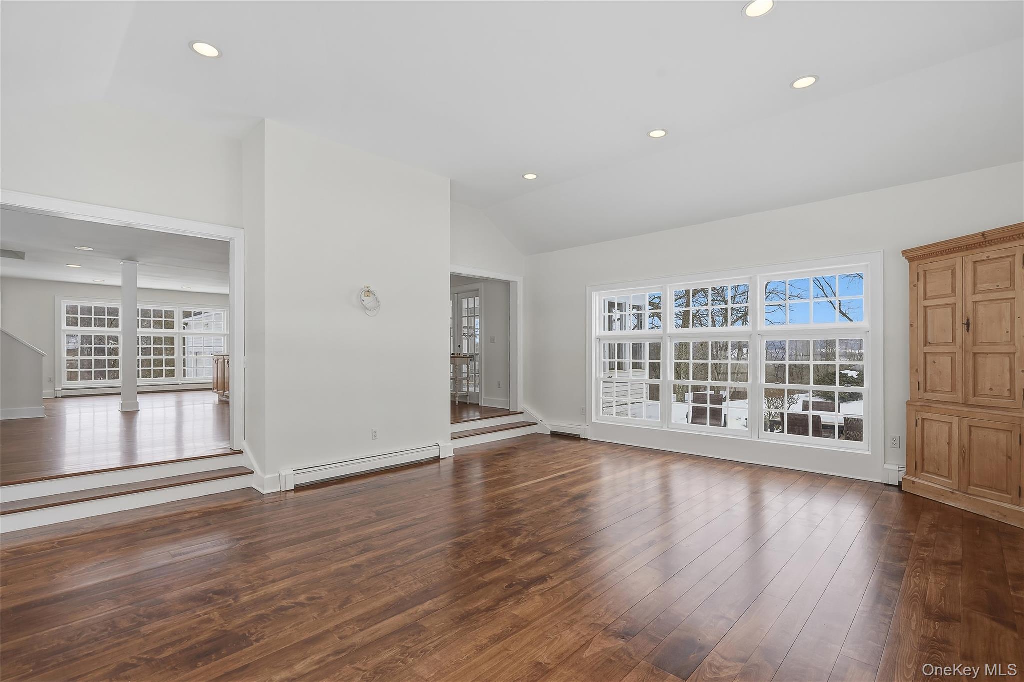 492 Mooney Hill Road, Unit 490 Patterson, NY 12563 - Photo 10 of 18 a view of an empty room with wooden floor and a window