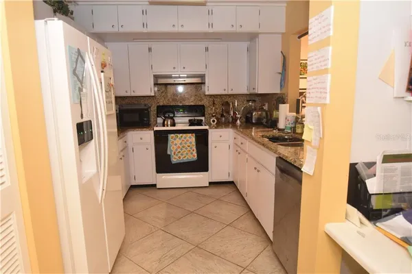 a kitchen with stainless steel appliances a refrigerator sink and stove