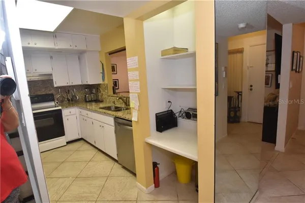 a kitchen with a sink appliances and cabinets