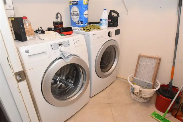 a utility room with sink dryer and washer