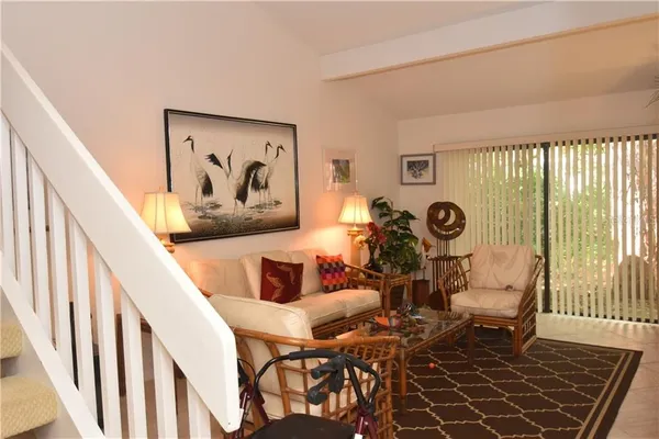 a view of a dining room with furniture and a large window