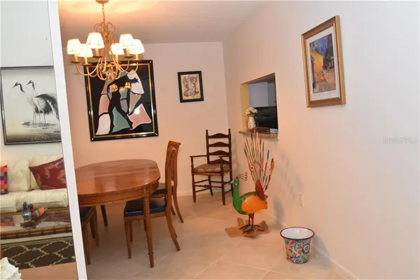 a view of a dining room with furniture and chandelier
