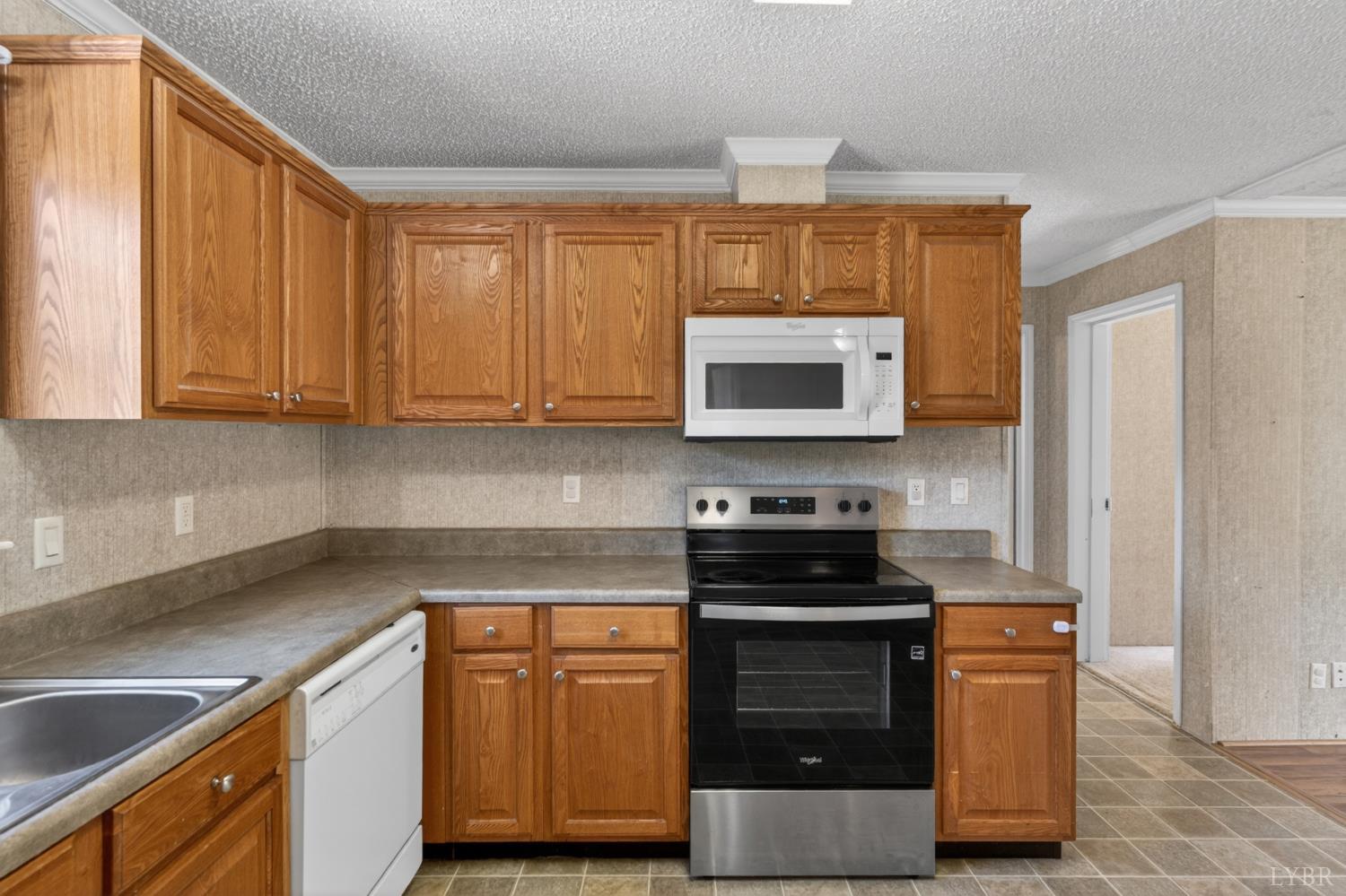 1811 Mohawk Road Gladys, VA 24554 - Photo 17 of 51 a kitchen with stainless steel appliances granite countertop a stove a sink and a microwave