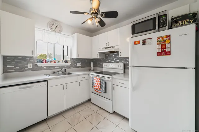 a kitchen with stainless steel appliances a sink and a refrigerator