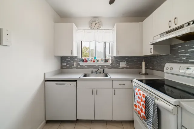 a kitchen with a sink stove and cabinets