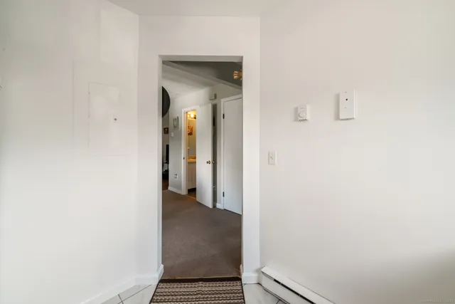 a view of a room with wooden floor and a small space