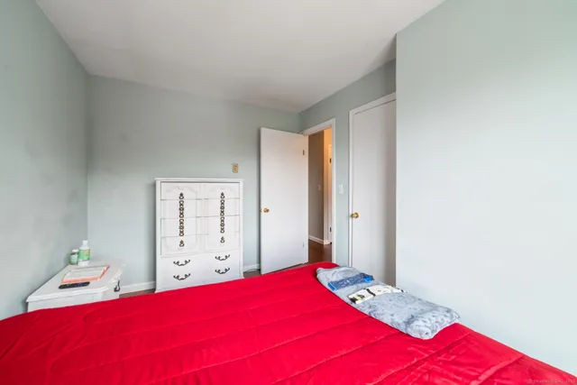 a bedroom with a large bed and a window