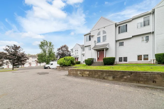 a couple of cars parked in front of a house
