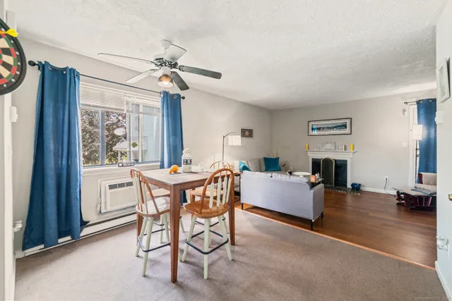 a dining room with furniture a chandelier and wooden floor