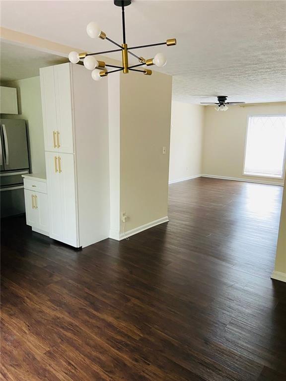 3293 Abbeywood Drive Decatur, GA 30034 - Photo 16 of 56 a view of a room with wooden floor a ceiling fan and kitchen view