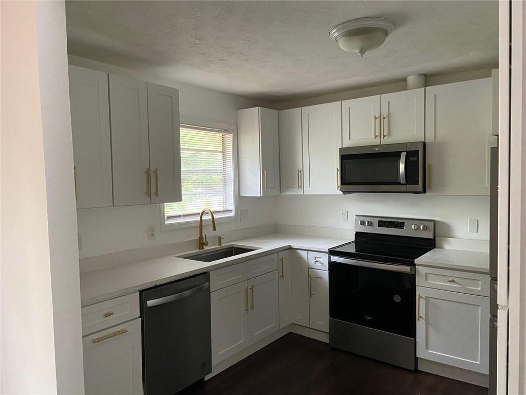 3293 Abbeywood Drive Decatur, GA 30034 - Photo 19 of 56 a kitchen with a sink stove and microwave