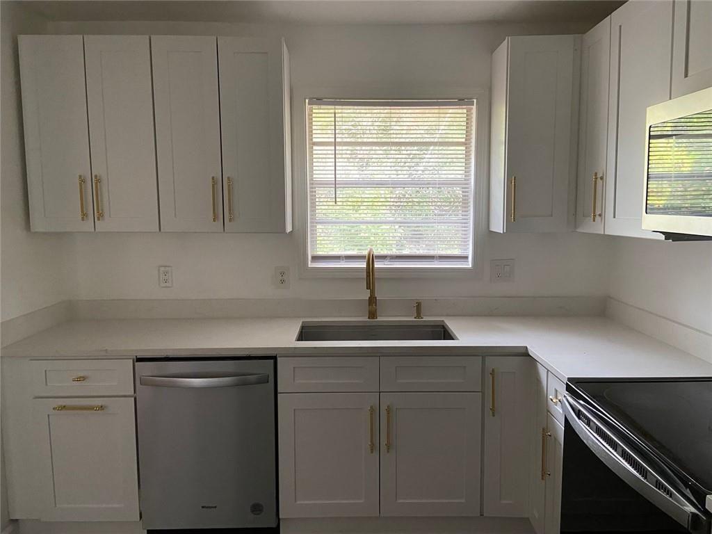 3293 Abbeywood Drive Decatur, GA 30034 - Photo 20 of 56 a kitchen with white cabinets and a sink