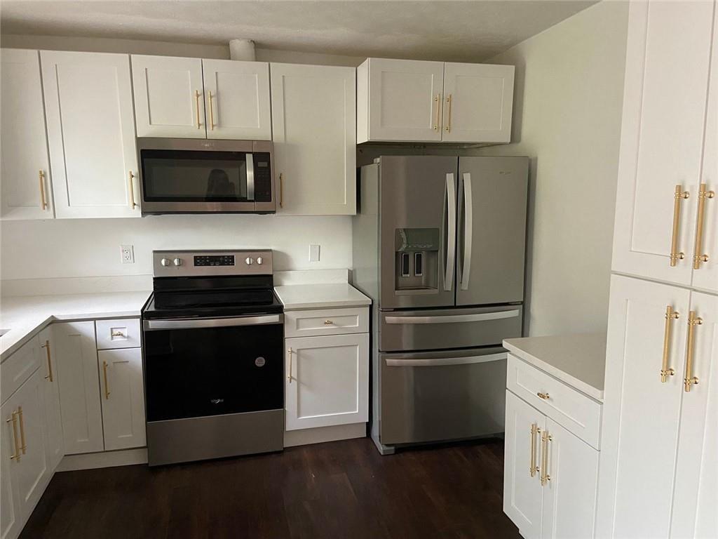 3293 Abbeywood Drive Decatur, GA 30034 - Photo 21 of 56 a kitchen with stainless steel appliances white cabinets and a granite counter tops