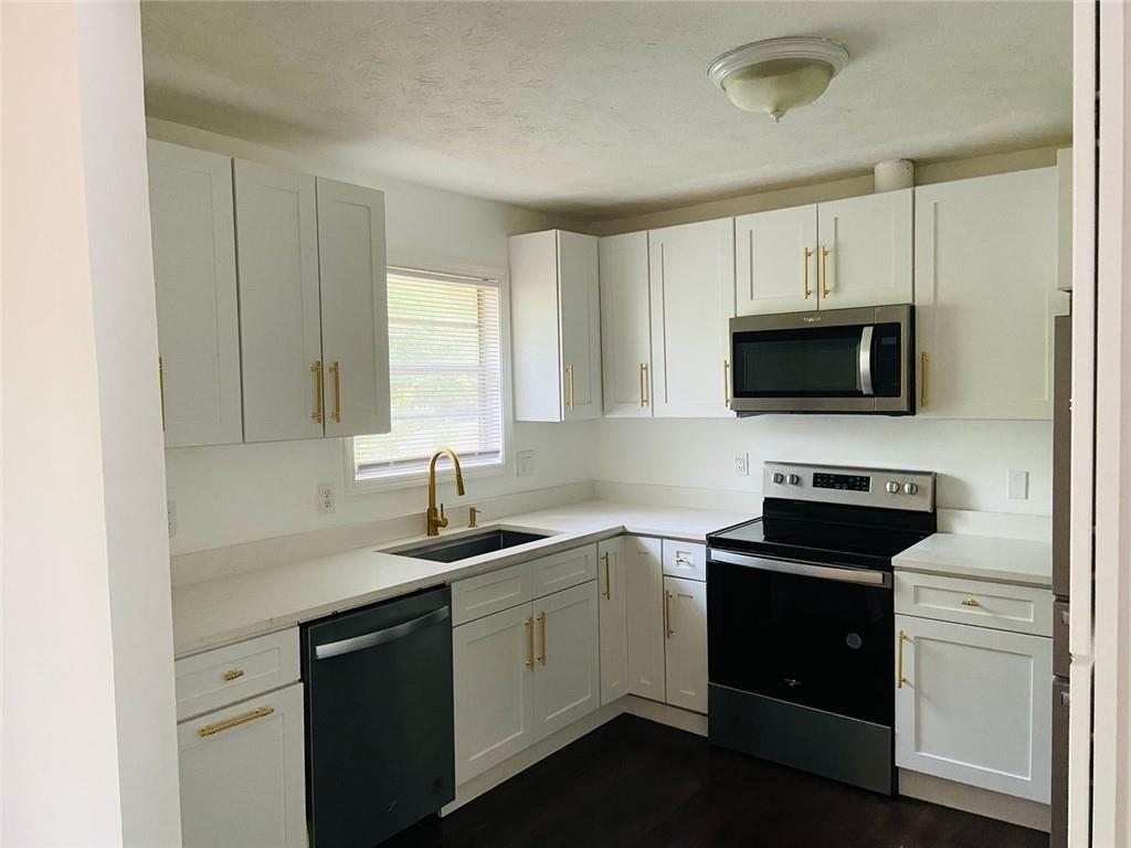 3293 Abbeywood Drive Decatur, GA 30034 - Photo 22 of 56 a kitchen with a sink stove and microwave