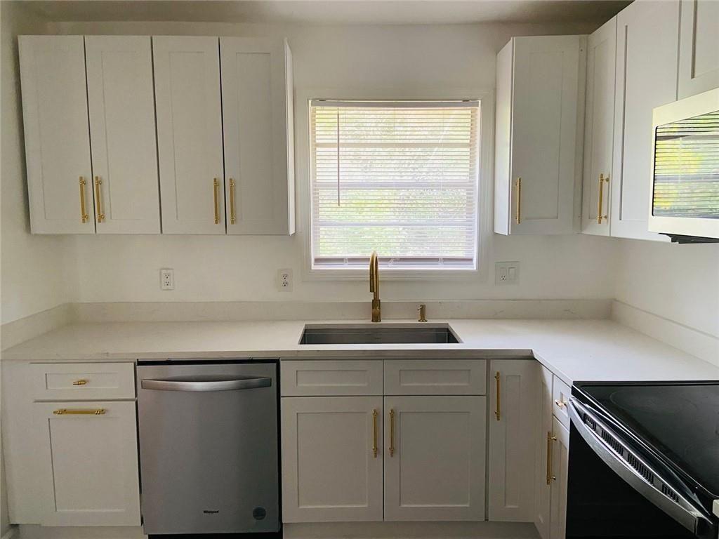 3293 Abbeywood Drive Decatur, GA 30034 - Photo 23 of 56 a kitchen with white cabinets and white appliances