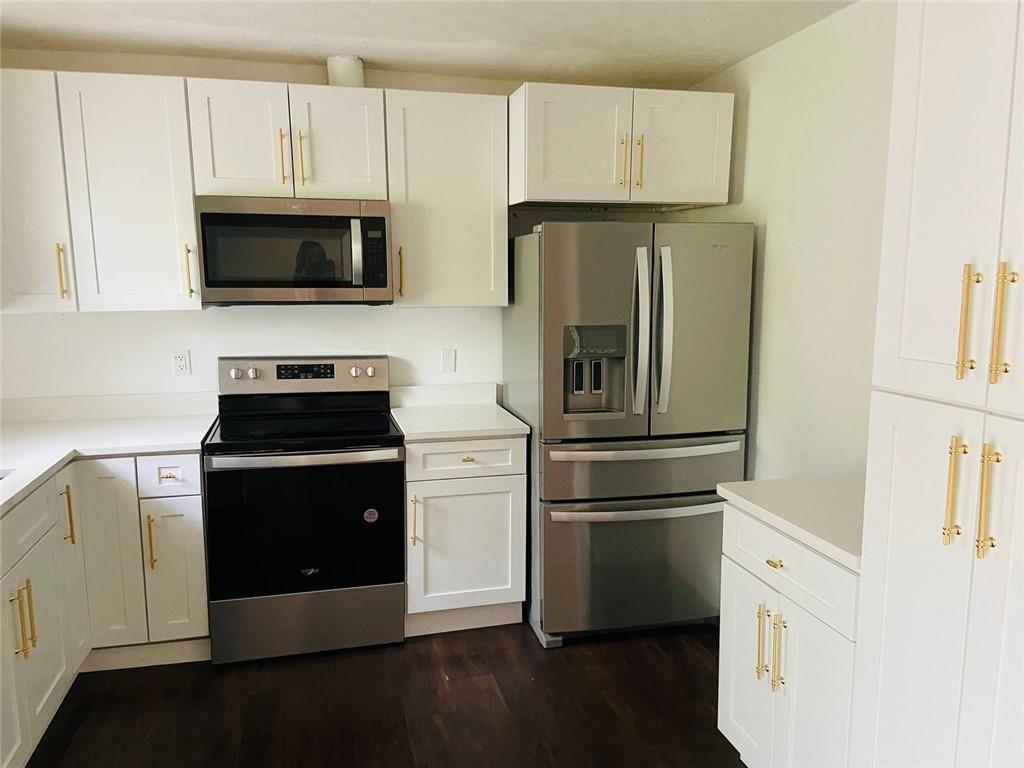 3293 Abbeywood Drive Decatur, GA 30034 - Photo 24 of 56 a kitchen with stainless steel appliances white cabinets and a granite counter tops