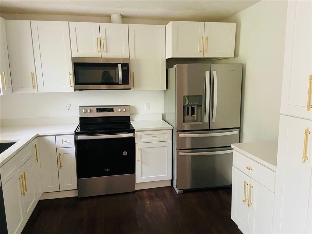 3293 Abbeywood Drive Decatur, GA 30034 - Photo 25 of 56 a kitchen with white cabinets and stainless steel appliances