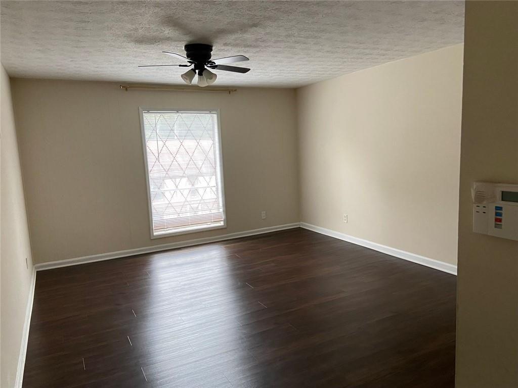 3293 Abbeywood Drive Decatur, GA 30034 - Photo 30 of 56 an empty room with wooden floor chandelier fan and windows