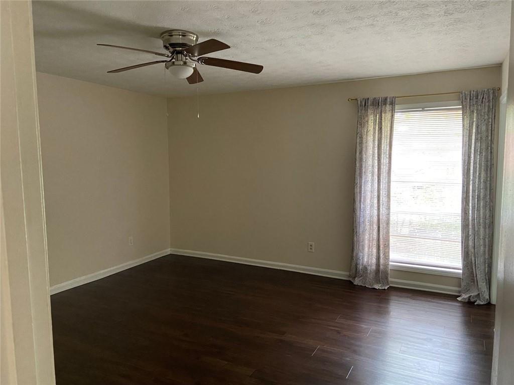 3293 Abbeywood Drive Decatur, GA 30034 - Photo 32 of 56 an empty room with wooden floor fan and windows
