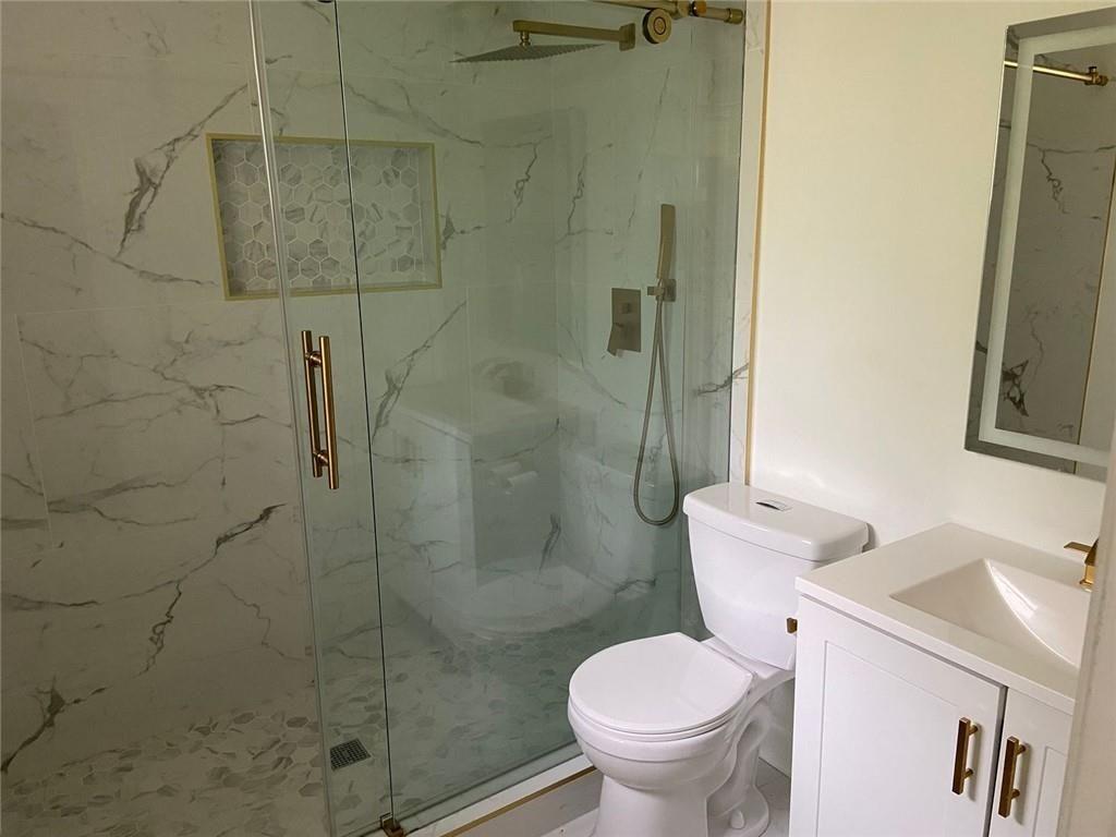 3293 Abbeywood Drive Decatur, GA 30034 - Photo 37 of 56 a white toilet sitting next to a bathroom sink