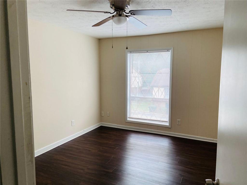 3293 Abbeywood Drive Decatur, GA 30034 - Photo 42 of 56 an empty room with wooden floor fan and windows