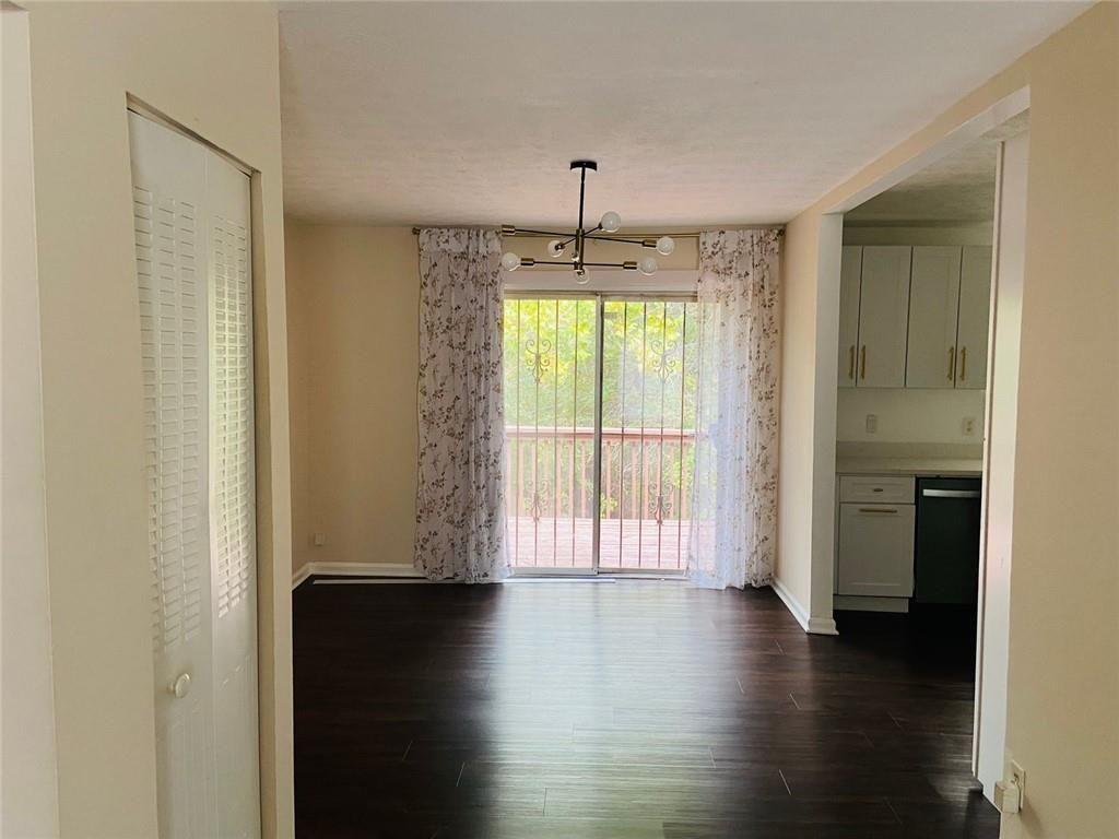 3293 Abbeywood Drive Decatur, GA 30034 - Photo 8 of 56 a view of an empty room with wooden floor and a window