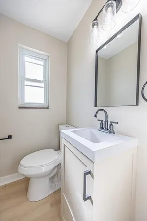 a bathroom with a toilet sink and mirror
