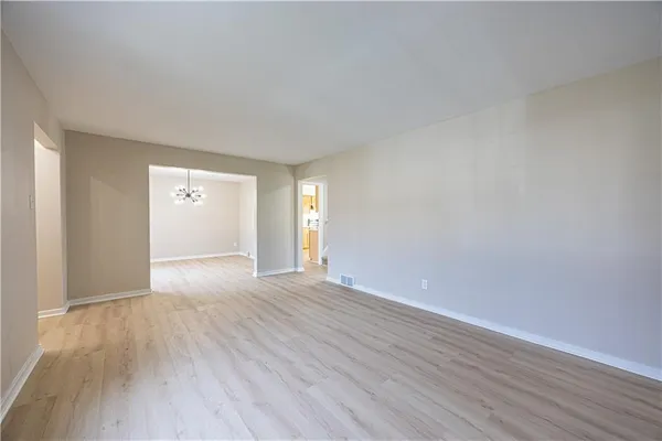 a view of an empty room and wooden floor