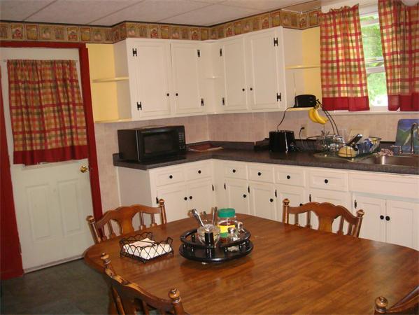 266 Nottingham Street Springfield, MA 01104 - Photo 6 of 13 a kitchen with a sink a stove and white cabinets