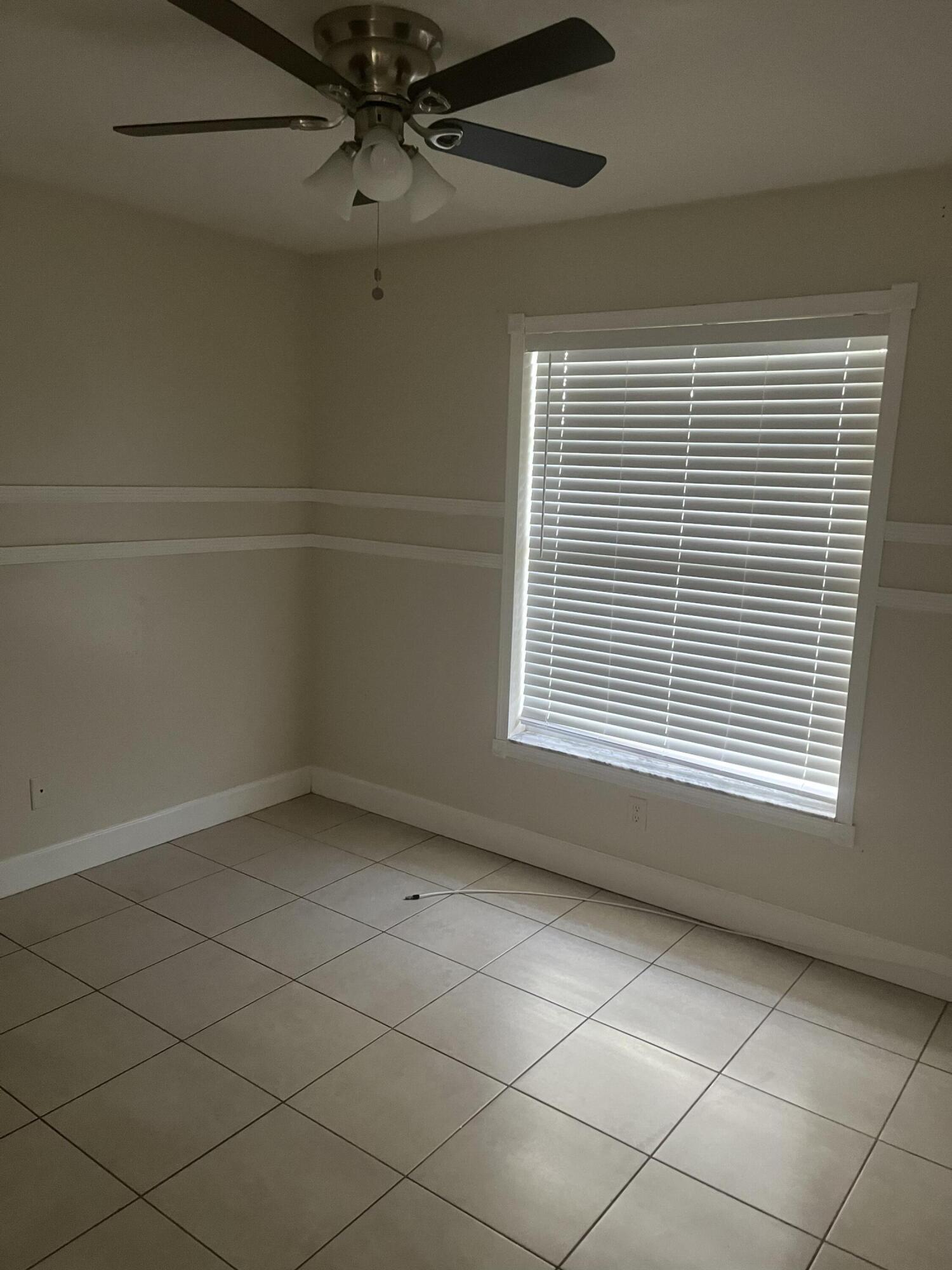 702 Southwest Amber Terrace Port St. Lucie, FL 34953 - Photo 13 of 16 a view of an empty room with a window