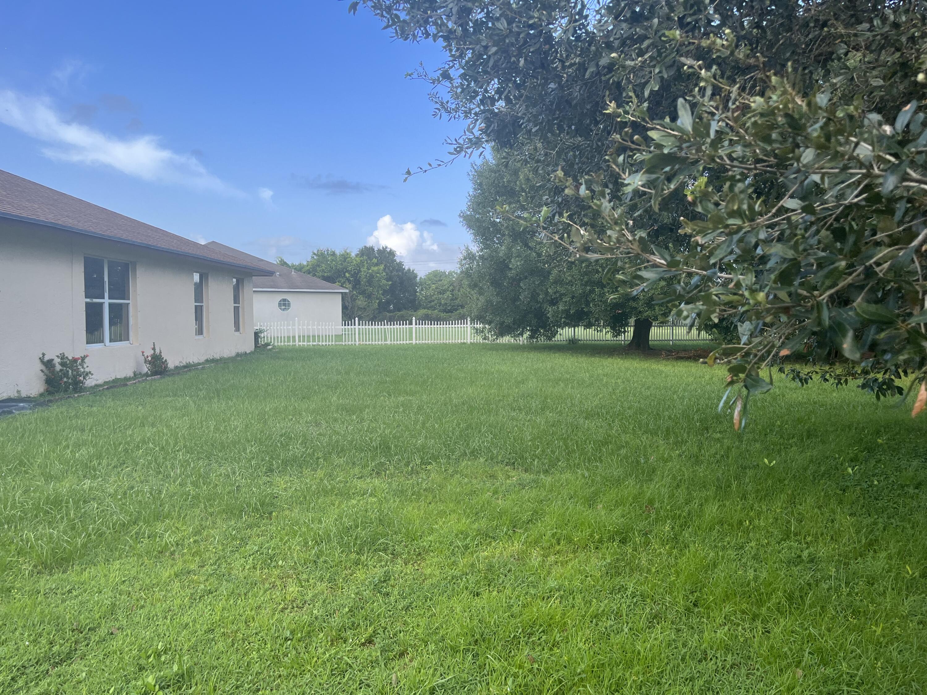 702 Southwest Amber Terrace Port St. Lucie, FL 34953 - Photo 16 of 16 a view of a backyard of the house