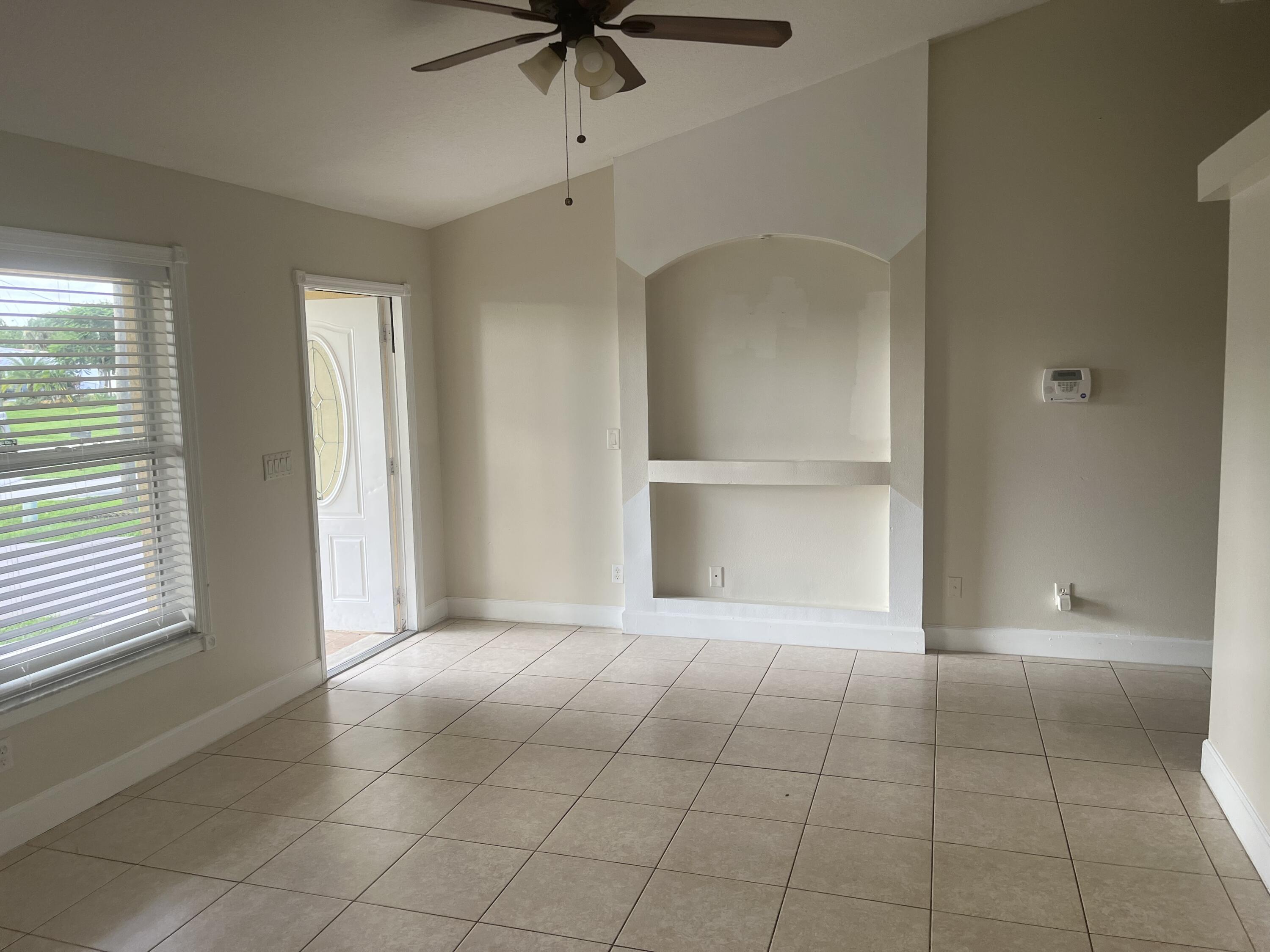 702 Southwest Amber Terrace Port St. Lucie, FL 34953 - Photo 3 of 16 a view of an empty room with a window