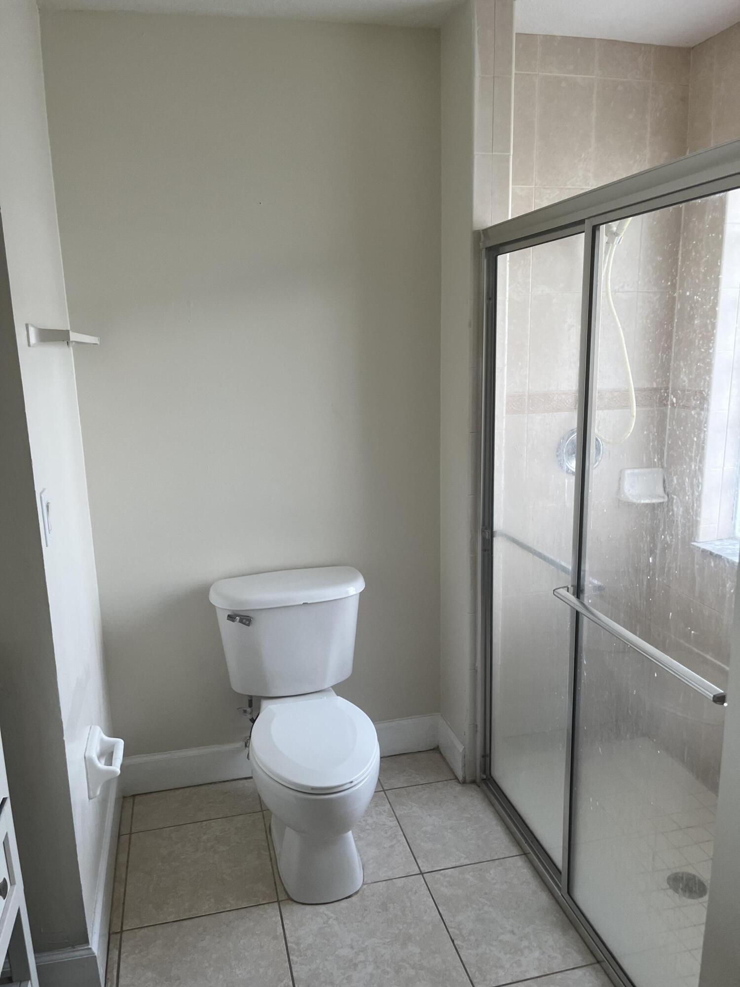 702 Southwest Amber Terrace Port St. Lucie, FL 34953 - Photo 8 of 16 a bathroom with a toilet and a shower
