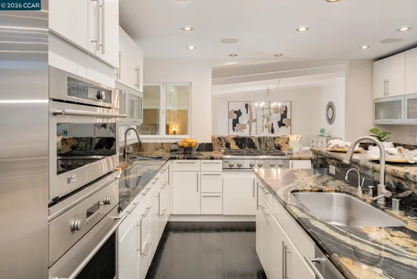 a kitchen with stainless steel appliances granite countertop a sink and cabinets