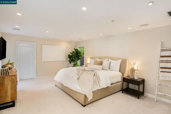 a spacious bedroom with a bed and a couch