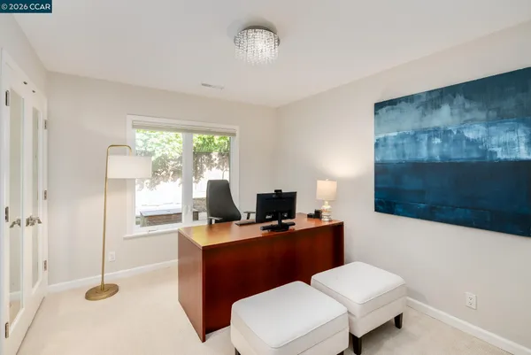 a dining room with furniture a chandelier and a rug