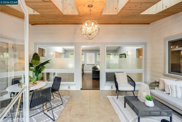 a kitchen with a dining table chairs stove and kitchen view