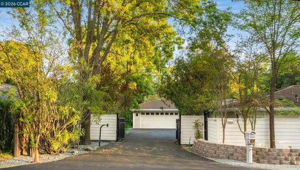 a front view of a house with a tree