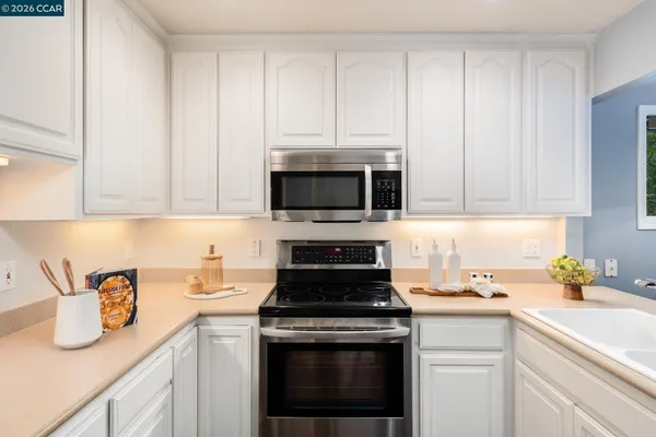 a spacious bathroom with a mirror a sink and a shower