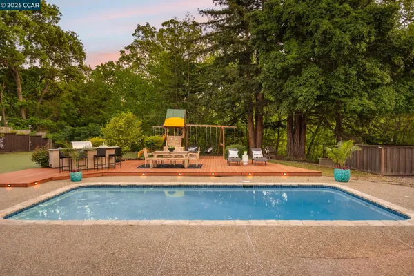 a backyard of a house with table and chairs