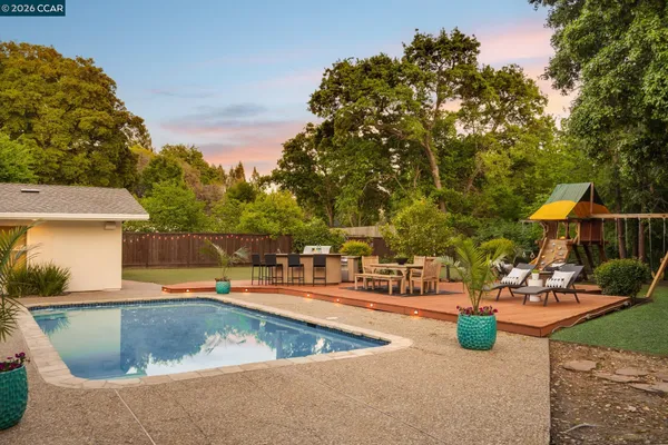 a view of a swimming pool with an outdoor seating and a yard