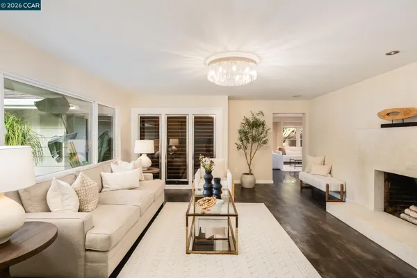 a living room with furniture fireplace and a large window
