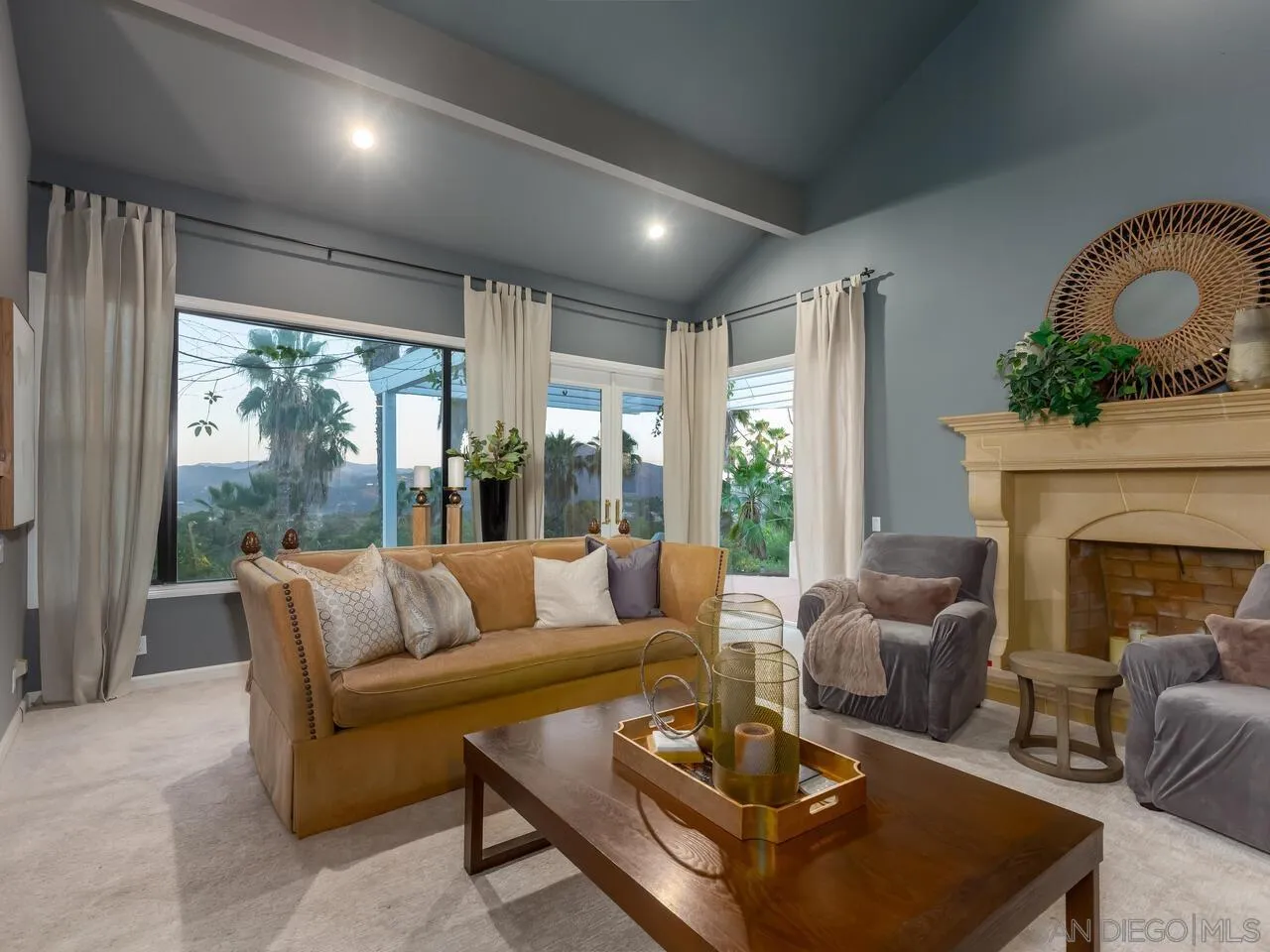 11630 Shadowglen Road El Cajon, CA 92020 - Photo 19 of 64 a living room with furniture fireplace and floor to ceiling windows