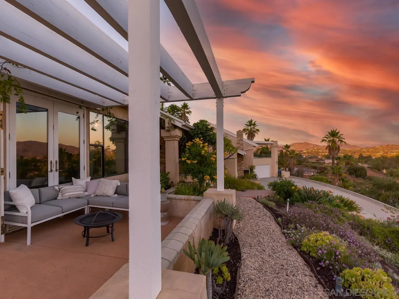 11630 Shadowglen Road El Cajon, CA 92020 - Photo 21 of 64 a view of a patio with table and chairs potted plants with floor to ceiling window