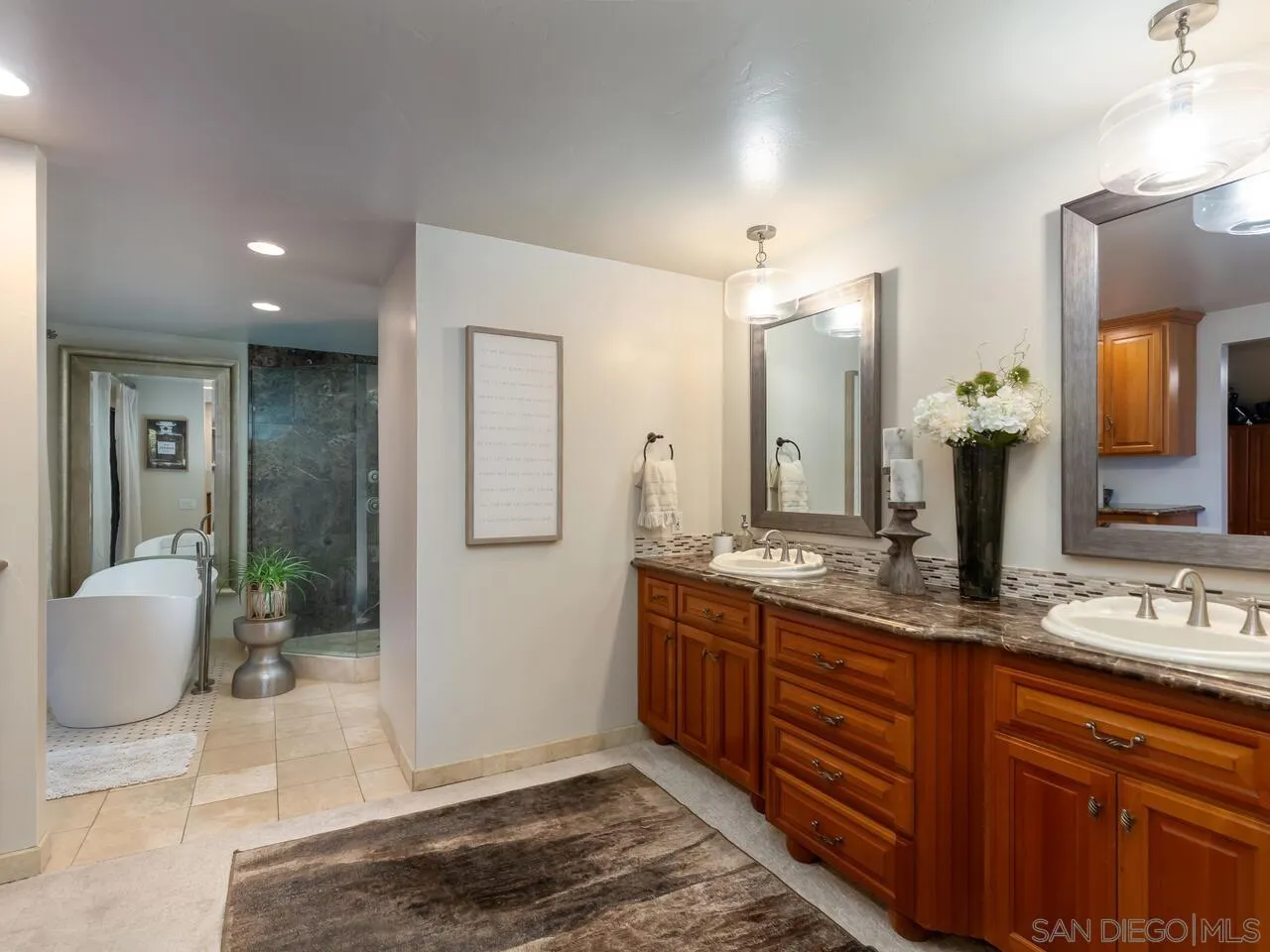 11630 Shadowglen Road El Cajon, CA 92020 - Photo 35 of 64 a spacious bathroom with a granite countertop sink and a mirror