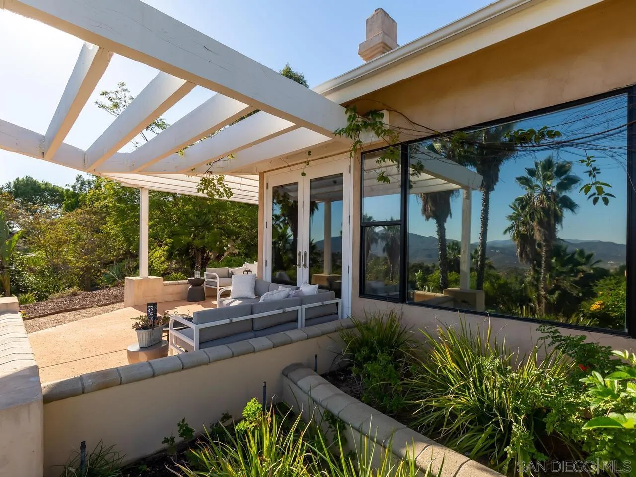 11630 Shadowglen Road El Cajon, CA 92020 - Photo 57 of 64 a view of a patio with couches table and chairs and potted plants