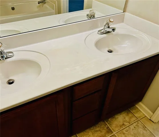 a bathroom with a sink and a mirror